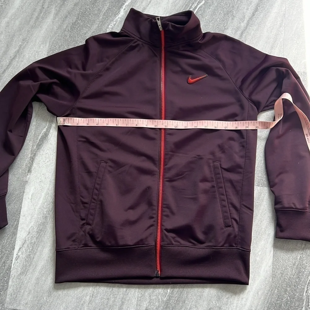 Maroon Nike Jacket size XL Youth black and orange detailing fits womens M/L
